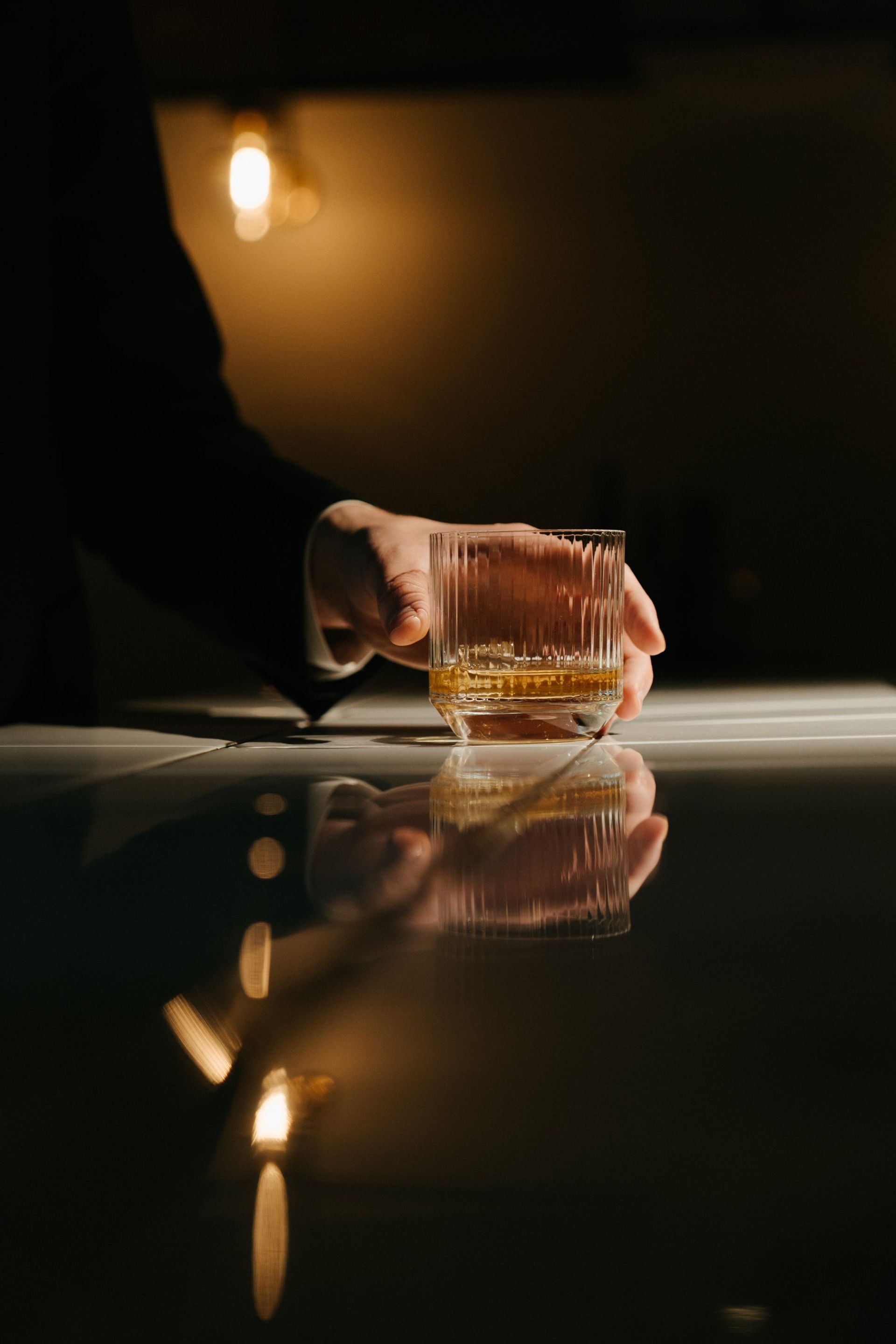 Person Holding Clear Glass Mug With Brown Liquid